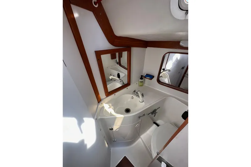 Slide: The Image of Bathroom interior of 1996 J Boats J/120 yacht with sink, mirror, and toilet. - 66