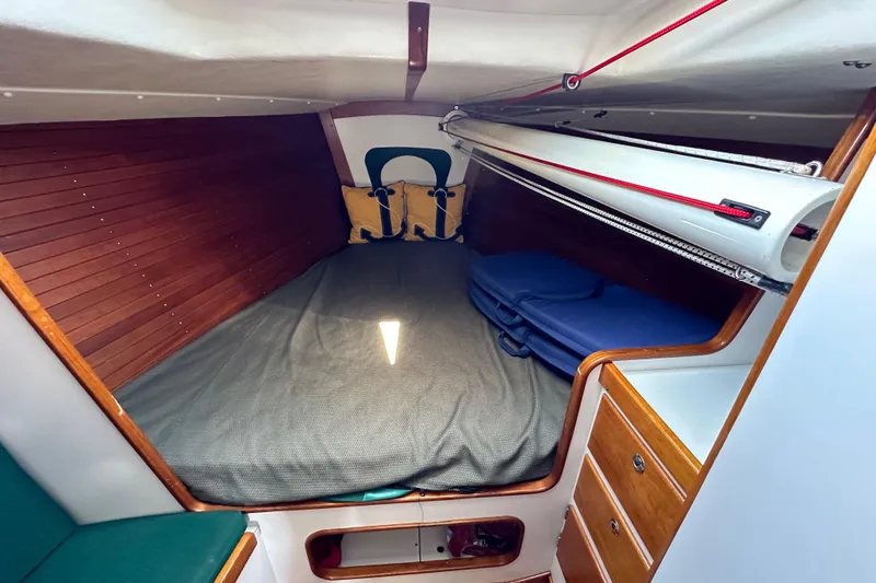 Slide: The Image of Cozy cabin interior of 1996 J Boats J/120 with wooden paneling and storage. - 74