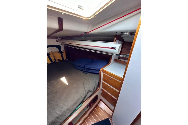 Slide: The Image of Cozy cabin interior of 1996 J Boats J/120 with wooden drawers and bedding. - 75