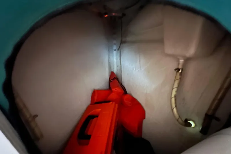 Slide: The Image of Interior view of a 1996 J Boats J/120 sailboat storage compartment with equipment. - 77