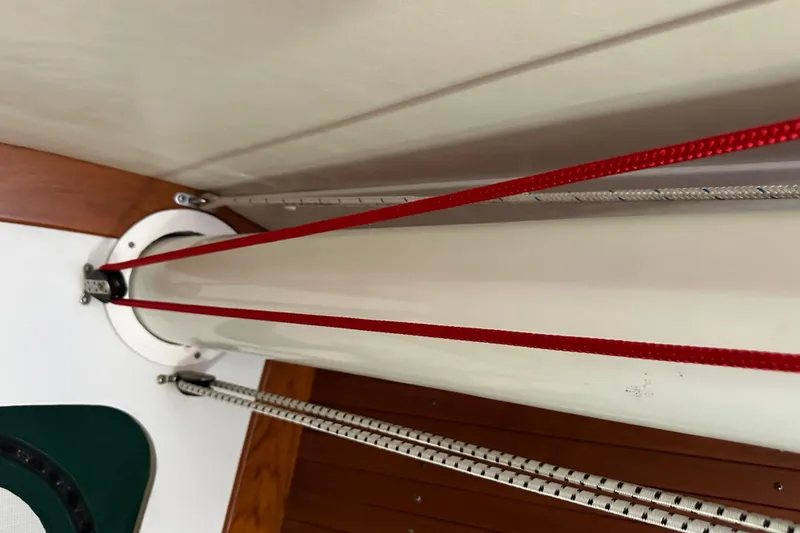 Slide: The Image of Interior view of 1996 J Boats J/120 sailboat mast with red and white ropes. - 78