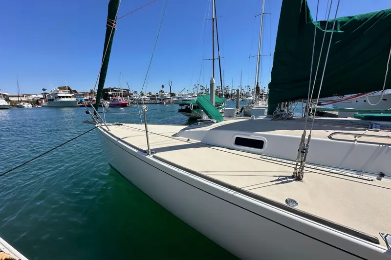 Slide: The Image of 1996 J Boats J/120 sailboat docked in a marina under clear blue skies. - 8
