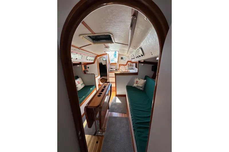 Slide: The Image of Interior of 1996 J Boats J/120 sailboat with cozy seating and wooden accents. - 81