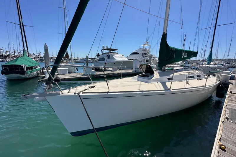 Slide: The Image of 1996 J Boats J/120 sailboat docked in a marina under clear blue skies. - 9