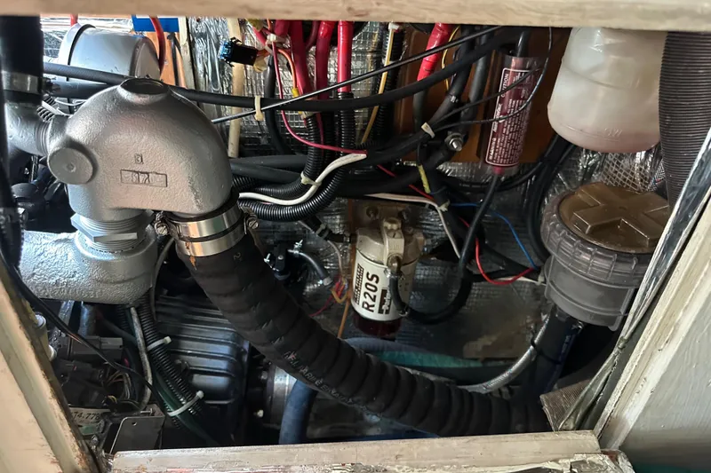 Slide: The Image of Engine compartment of a 1996 J Boats J/120 sailboat, showing mechanical components and wiring. - 90