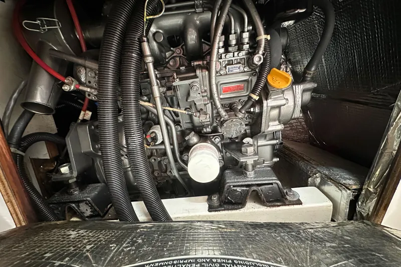 Slide: The Image of Engine compartment of a 1996 J Boats J/120 sailboat, showcasing detailed mechanical components. - 92