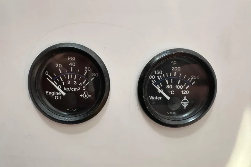 Slide: The Image of Engine oil and water temperature gauges on a 1996 J Boats J/120 yacht. - 93