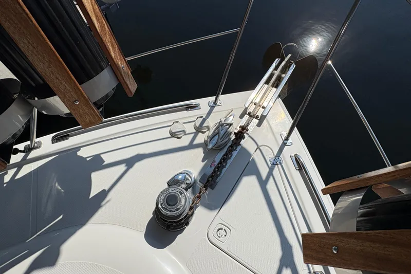 Slide: The Image of 2002 Carver 506 Motor Yacht anchor system with winch and chain on deck. - 21