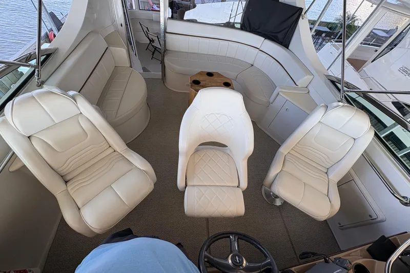 Slide: The Image of Luxurious interior of a 2002 Carver 506 Motor Yacht with plush white seating. - 24