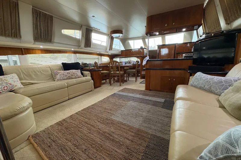 Slide: The Image of Luxurious interior of 2002 Carver 506 Motor Yacht with elegant seating and dining area. - 34