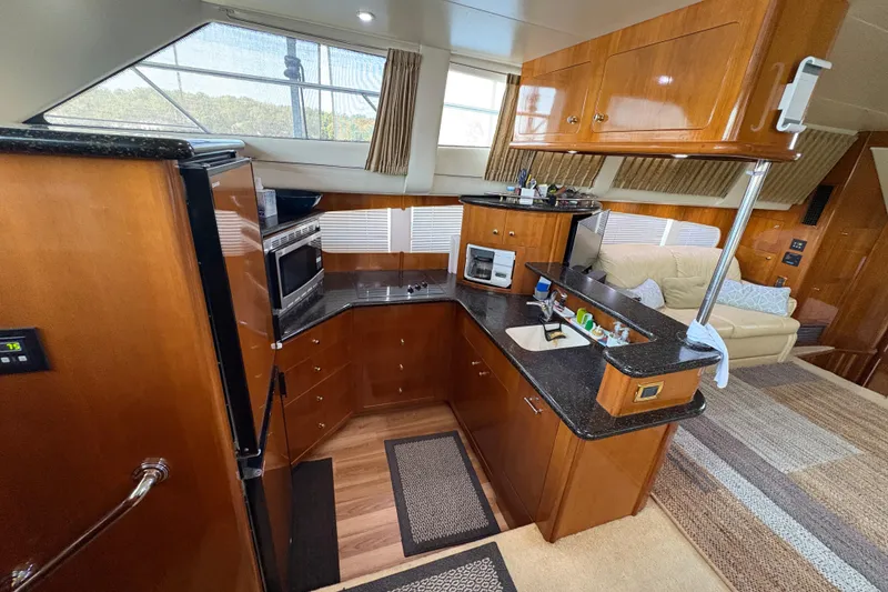 Slide: The Image of Luxurious interior of 2002 Carver 506 Motor Yacht with modern kitchen and seating area. - 39