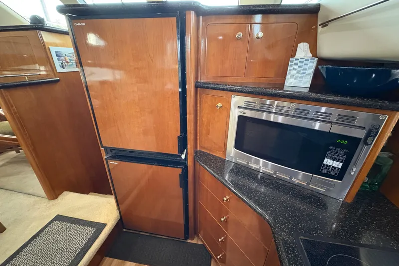 Slide: The Image of Interior of 2002 Carver 506 Motor Yacht kitchen with fridge and microwave. - 40