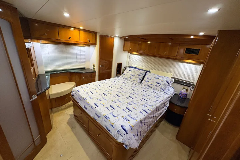 Slide: The Image of Luxurious bedroom interior of 2002 Carver 506 Motor Yacht with wood cabinetry and nautical bedding. - 45