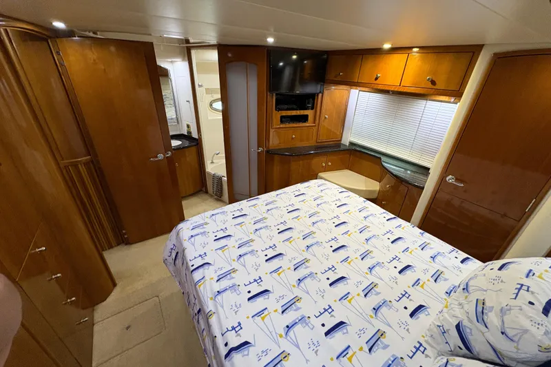 Slide: The Image of Luxurious interior of 2002 Carver 506 Motor Yacht with cozy bedroom and elegant wood finishes. - 47