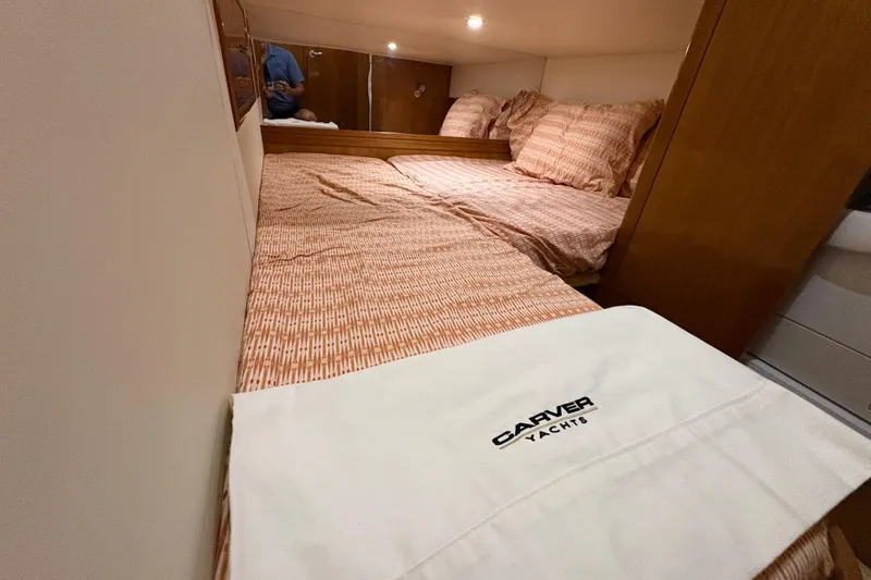 Slide: The Image of Cozy bedroom in 2002 Carver 506 Motor Yacht with patterned bedding and branded linens. - 51