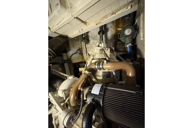 Slide: The Image of Engine room of 2002 Carver 506 Motor Yacht, showcasing mechanical components and piping. - 62