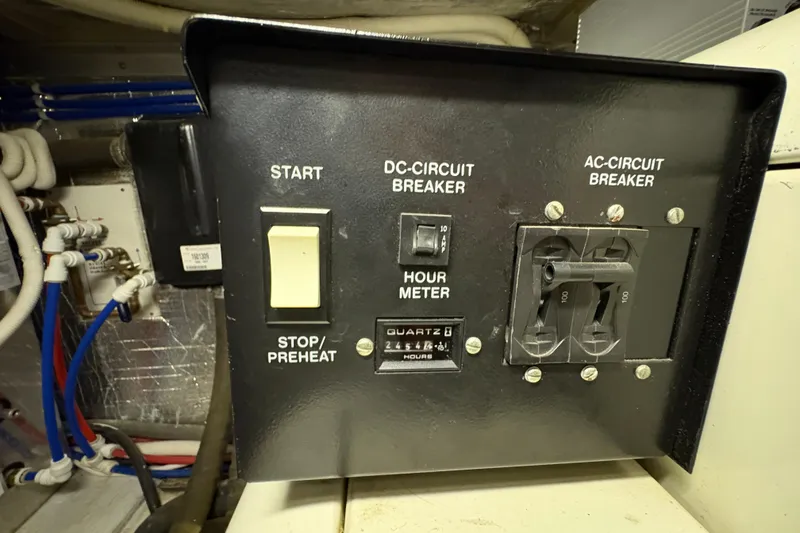 Slide: The Image of Control panel of a 2002 Carver 506 Motor Yacht with circuit breakers and hour meter. - 72