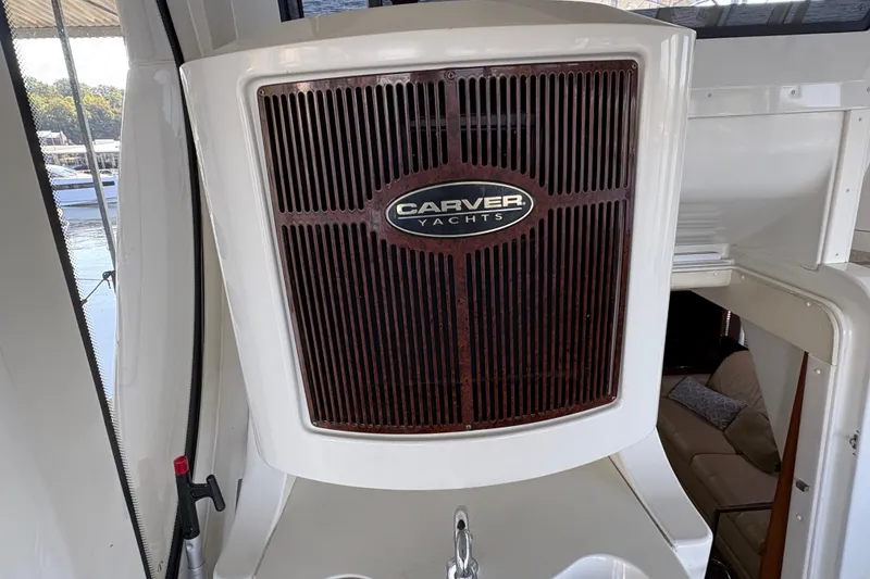 Slide: The Image of 2002 Carver 506 Motor Yacht interior with branded panel and seating area. - 16