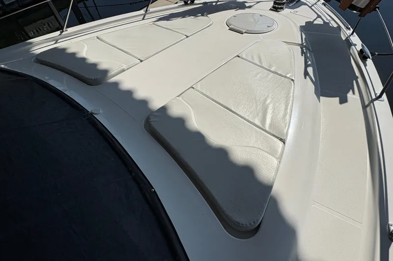 Slide: The Image of 2002 Carver 506 Motor Yacht deck with cushioned seating and hatch. - 19