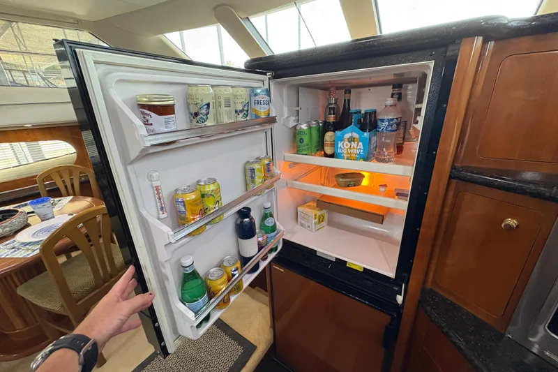 Slide: The Image of Open refrigerator inside 2002 Carver 506 Motor Yacht, stocked with beverages and food. - 41
