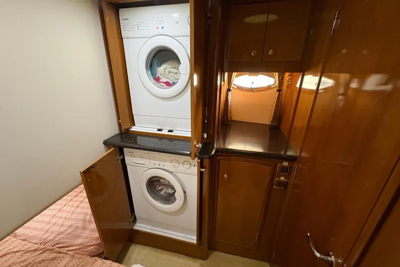 Slide: The Image of Laundry area in 2002 Carver 506 Motor Yacht with stacked washer and dryer. - 43