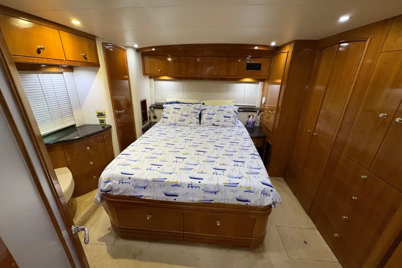 Slide: The Image of Luxurious bedroom in 2002 Carver 506 Motor Yacht with nautical-themed bedding. - 44
