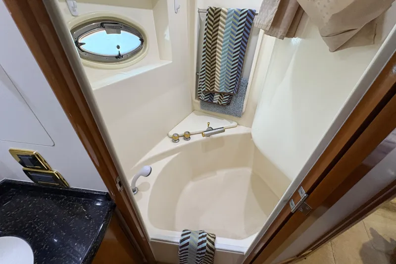 Slide: The Image of Bathroom interior of 2002 Carver 506 Motor Yacht with shower and porthole window. - 48