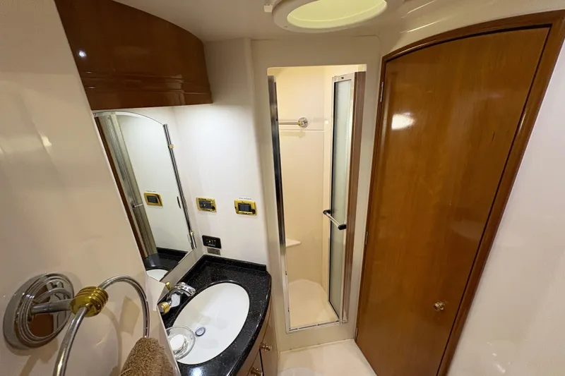 Slide: The Image of Luxurious bathroom in 2002 Carver 506 Motor Yacht with modern fixtures and wood accents. - 52