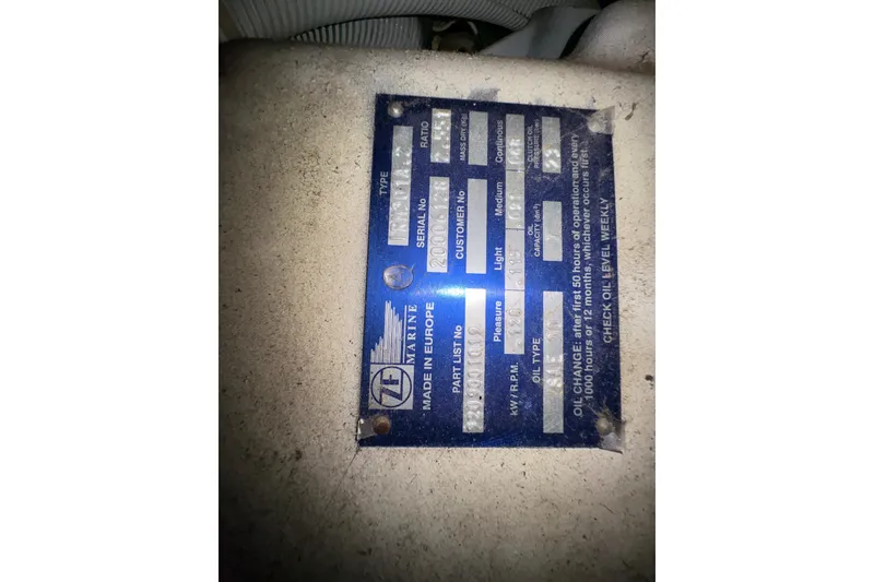 Slide: The Image of 2002 Carver 506 Motor Yacht engine plate with specifications and maintenance instructions. - 66