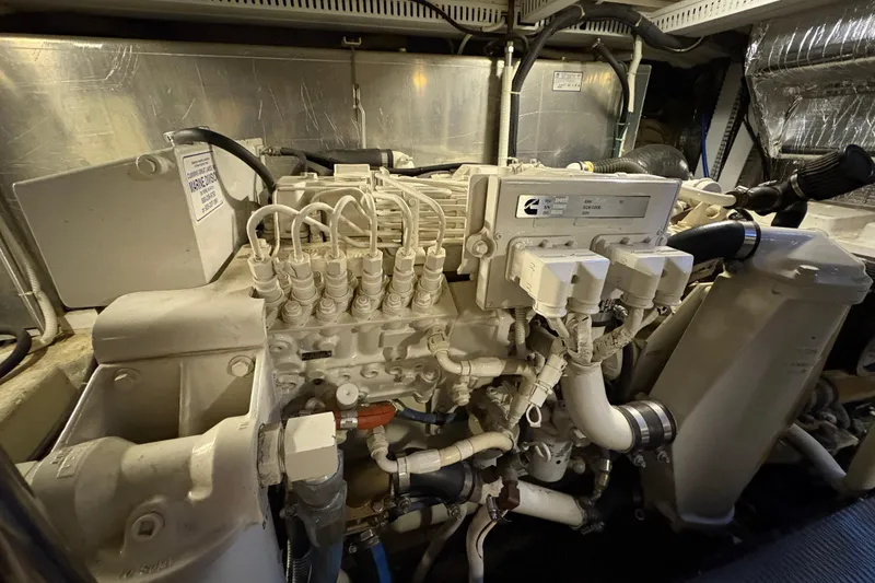 Slide: The Image of Engine room of a 2002 Carver 506 Motor Yacht, featuring a Cummins marine engine. - 70