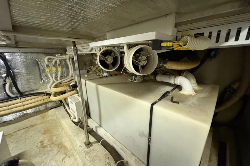 Slide: The Image of Engine room of 2002 Carver 506 Motor Yacht with pipes and ventilation system. - 74