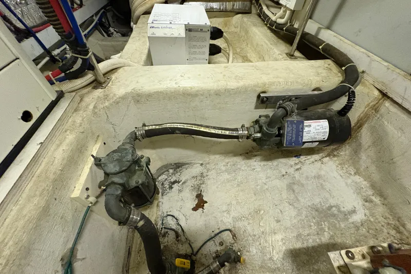 Slide: The Image of Engine room of 2002 Carver 506 Motor Yacht with visible pump and wiring. - 76
