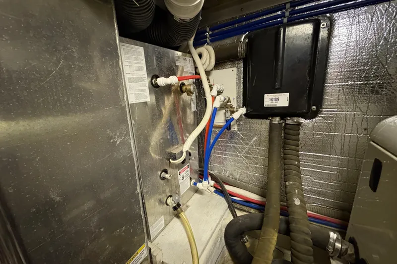 Slide: The Image of Engine room of 2002 Carver 506 Motor Yacht with pipes and wiring. - 80