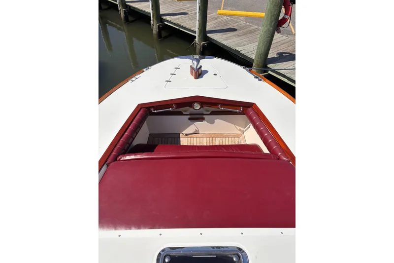 Slide: The Image of 2000 Santa Cruz Coastal Flyer 41 boat with red seating, docked at a wooden pier. - 11