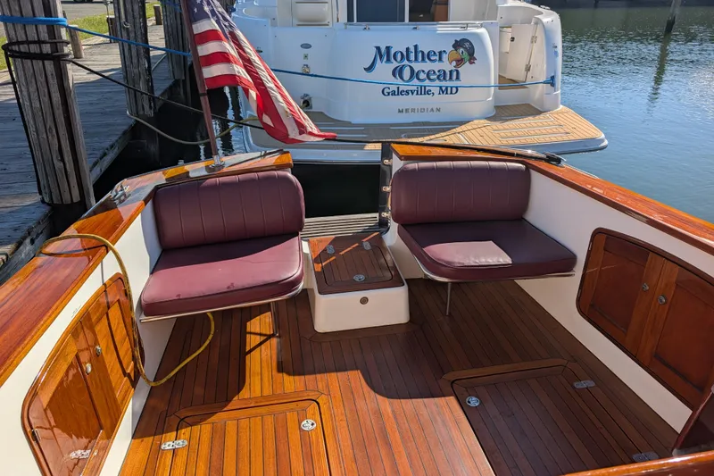 Slide: The Image of 2000 Santa Cruz Coastal Flyer 41 boat with wooden deck and seating, docked near "Mother Ocean." - 14