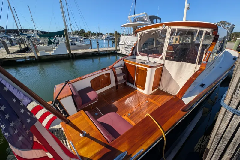 Slide: The Image of 2000 Santa Cruz Coastal Flyer 41 docked, featuring polished wood and American flag. - 16