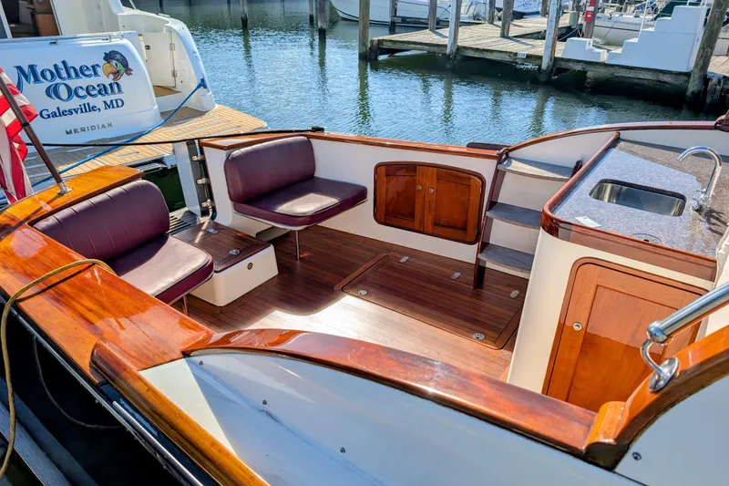 Slide: The Image of Luxurious 2000 Santa Cruz Coastal Flyer 41 boat interior with wooden deck and seating. - 19