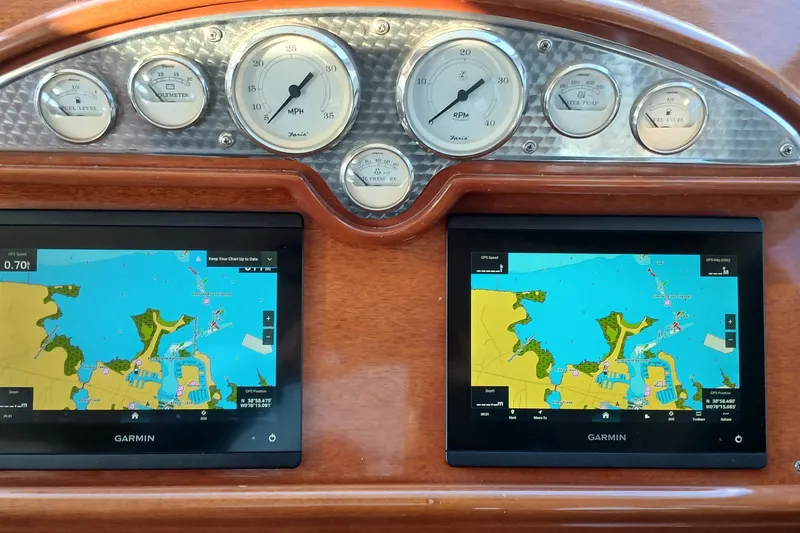 Slide: The Image of Dashboard of a 2000 Santa Cruz Coastal Flyer 41 with navigation screens and gauges. - 26