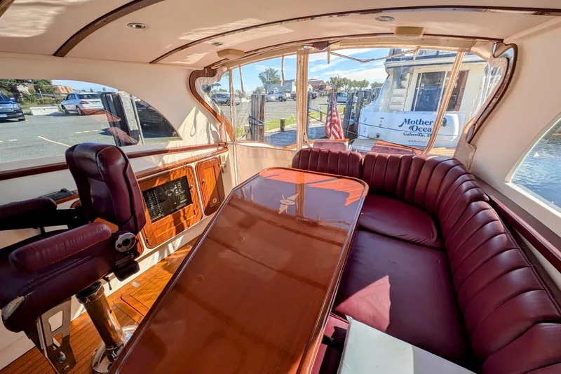 Slide: The Image of Interior of 2000 Santa Cruz Coastal Flyer 41 with luxurious seating and polished wood table. - 31