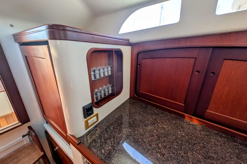 Slide: The Image of Interior of 2000 Santa Cruz Coastal Flyer 41 yacht with wooden cabinetry and granite countertop. - 33