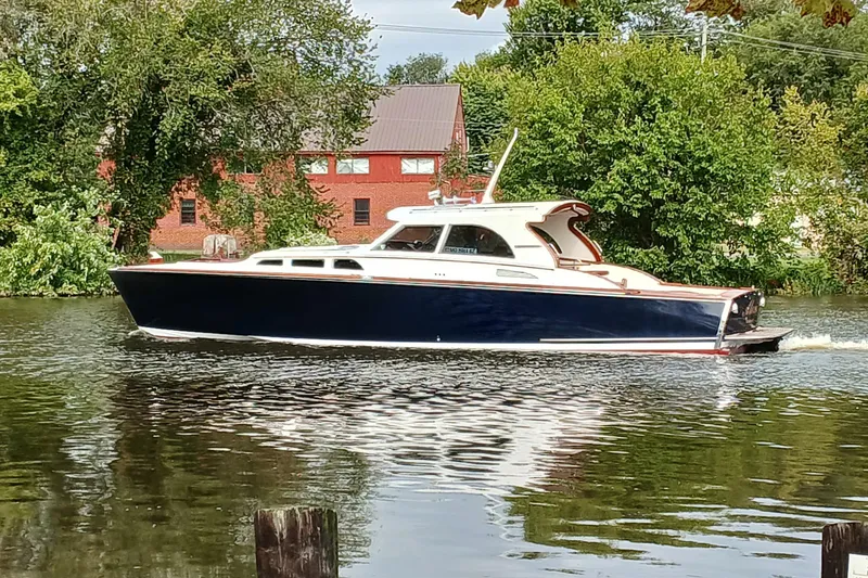 Slide: The Image of Santa Cruz Coastal Flyer 41 boat cruising on a serene river, surrounded by lush greenery. - 4
