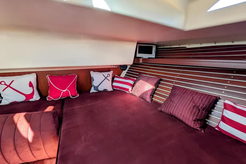 Slide: The Image of Interior of 2000 Santa Cruz Coastal Flyer 41 with nautical-themed cushions and cozy seating. - 40