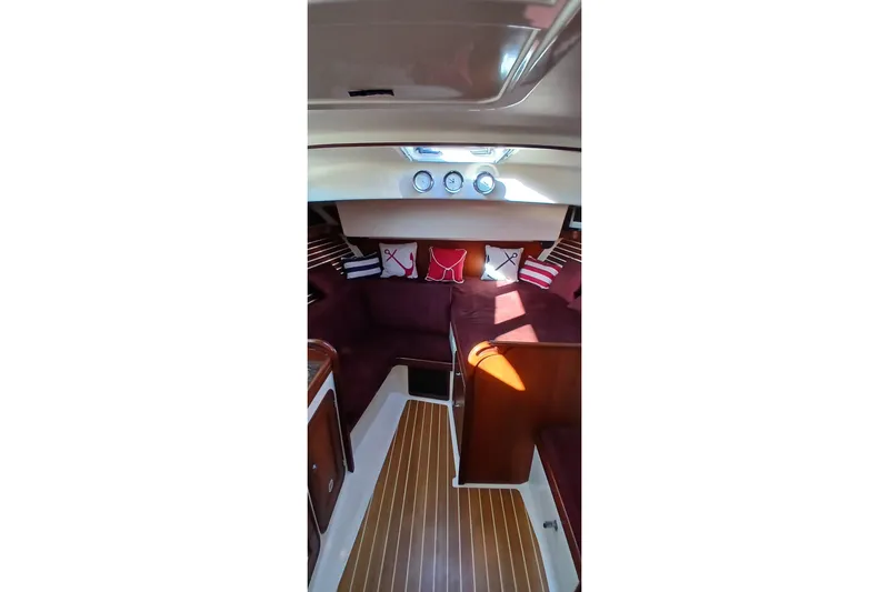 Slide: The Image of Interior of 2000 Santa Cruz Coastal Flyer 41 with maroon seating and nautical decor. - 45