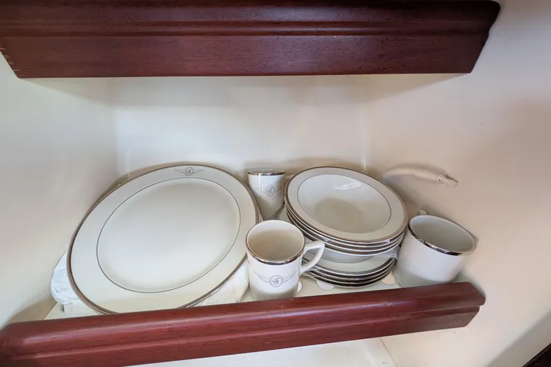 Slide: The Image of Elegant dinnerware set in a wooden cabinet on a 2000 Santa Cruz Coastal Flyer 41. - 50