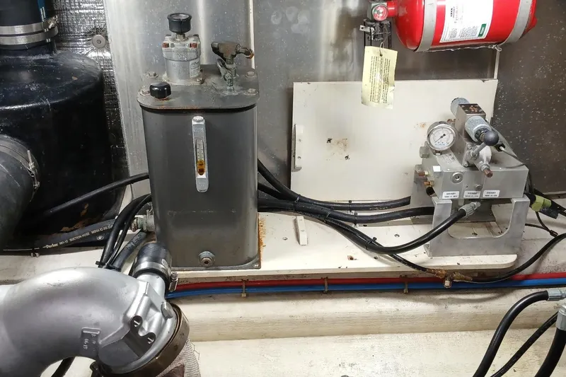 Slide: The Image of Engine room components of a 2000 Santa Cruz Coastal Flyer 41 boat, featuring gauges and fire extinguisher. - 56