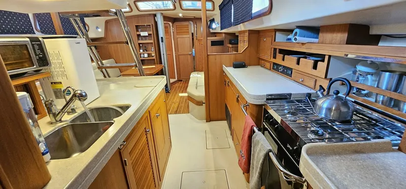 Slide: The Image of Interior of 2009 Island Packet 465 yacht with kitchen and dining area. - 10
