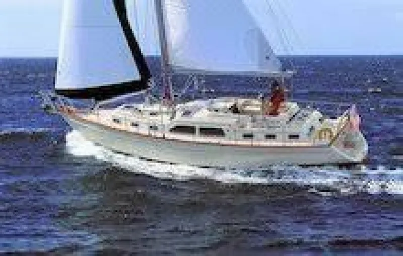 Slide: The Image of Sailing yacht Island Packet 465, 2009 model, cruising on open water near a bridge. - 16