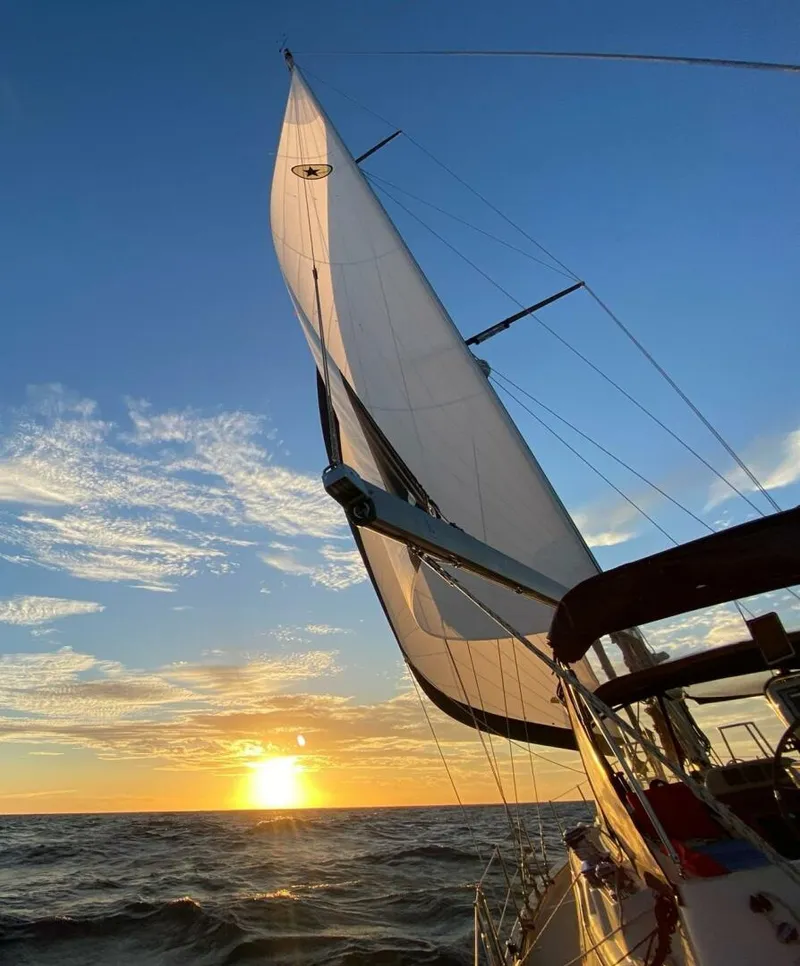 Slide: The Image of 2009 Island Packet 465 sailboat cruising near a bridge on a sunny day. - 17