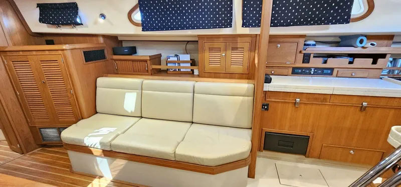Slide: The Image of Interior of 2009 Island Packet 465 yacht with beige seating and wooden cabinetry. - 3