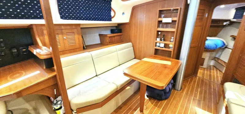 Slide: The Image of Cozy interior of 2009 Island Packet 465 yacht with wooden furnishings and seating area. - 4